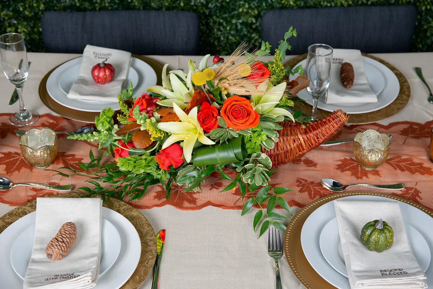 Beautiful fall-themed table setting with a vibrant floral centerpiece and elegant dinnerware.