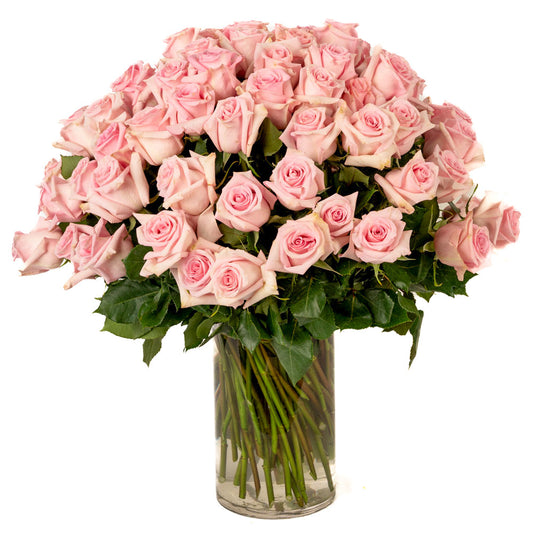 A stunning bouquet of fresh pink roses arranged elegantly in a tall glass vase. Perfect for any special occasion.