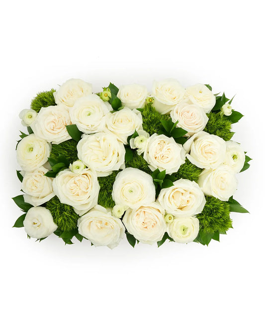 Elegant white ranunculus arranged with lush greens, perfect for weddings and special occasions.