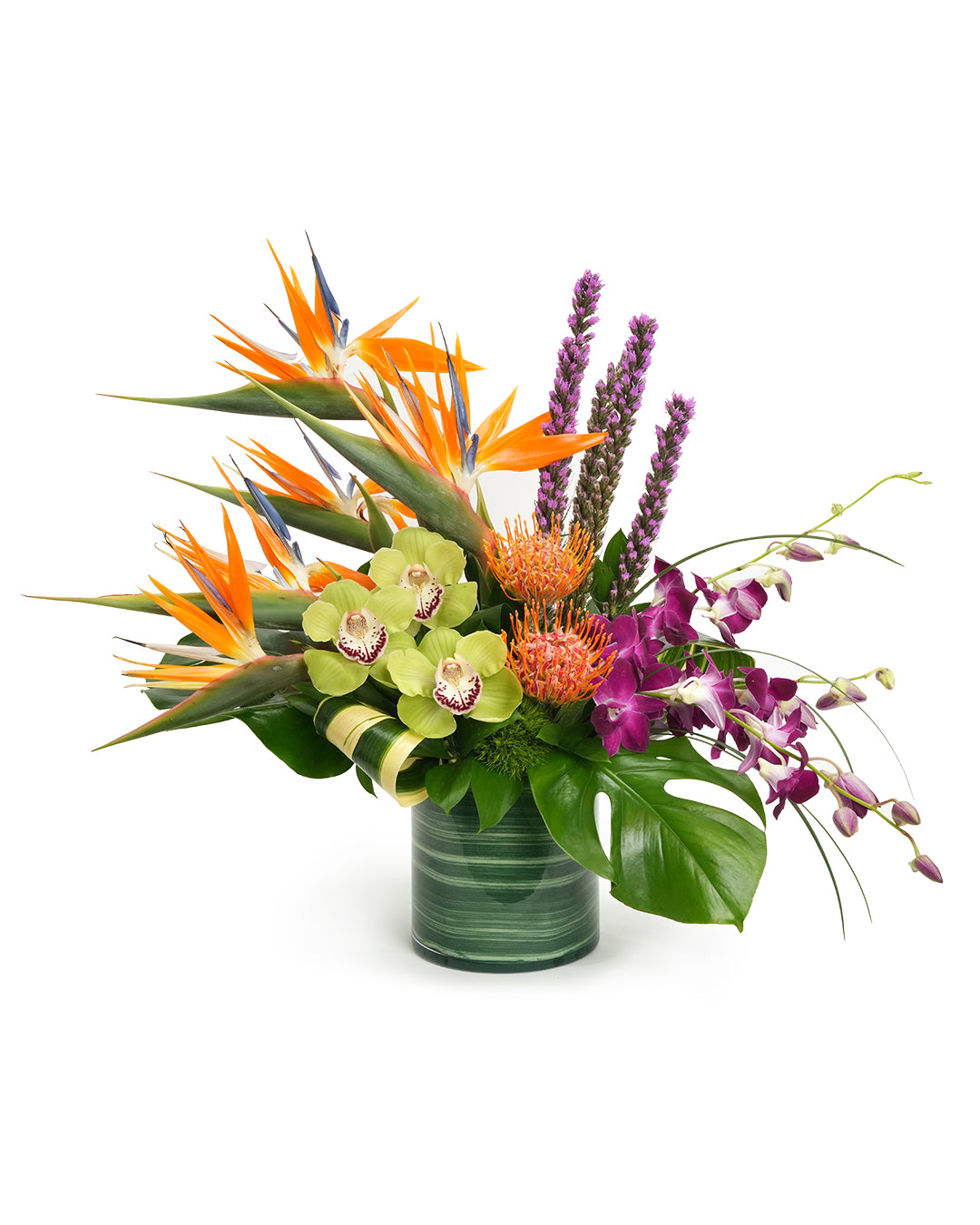 Vibrant tropical flower arrangement featuring bird of paradise, orchids, and colorful blooms in a sleek vase.