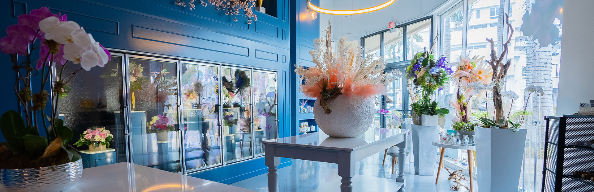 Brightly lit floral shop showcasing vibrant arrangements and elegant decor elements.