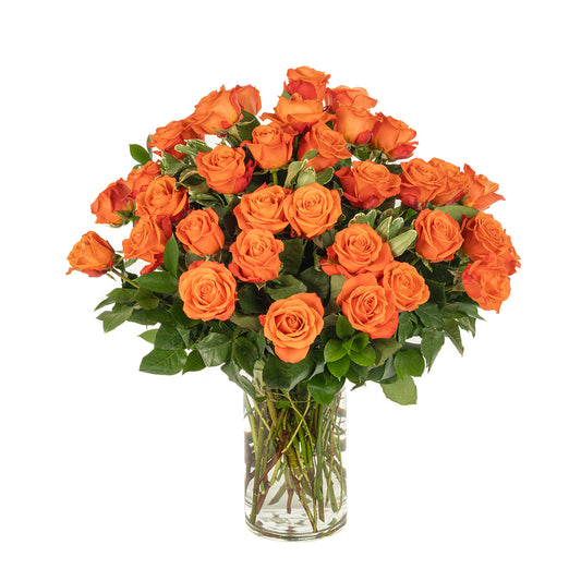 Vibrant bouquet of orange roses arranged in a clear glass vase, perfect for any special occasion.