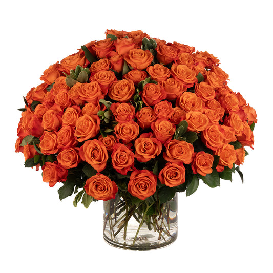 A stunning arrangement of vibrant orange roses in a clear glass vase, perfect for any occasion.