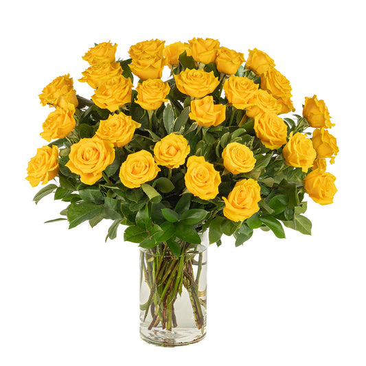 Vibrant bouquet of 24 fresh yellow roses in a clear glass vase, perfect for brightening any space.