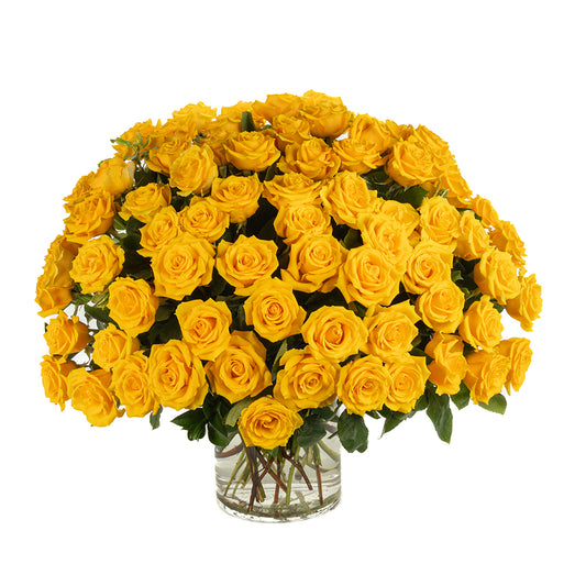 Bright and cheerful arrangement of fresh yellow roses in a glass vase, perfect for celebrations or gifts.