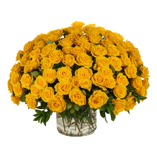 Vibrant yellow rose bouquet in a clear glass vase, perfect for brightening any space or occasion.
