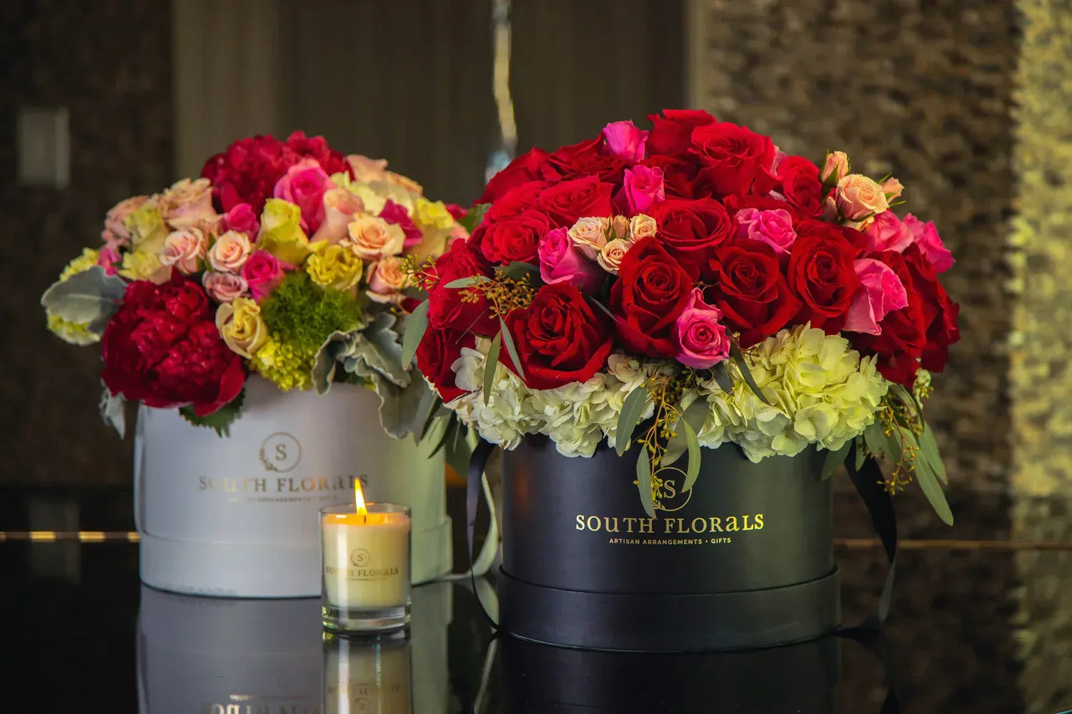 Elegant flower arrangements in chic boxes, featuring vibrant reds and soft pinks from South Florals.