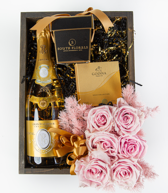 Luxury gift basket featuring Louis Roederer Champagne, Godiva chocolates, and pink roses for special occasions.