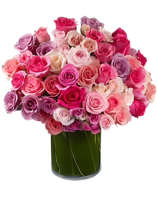 Vibrant bouquet of mixed pink and lavender roses in a stylish green vase, perfect for any occasion.