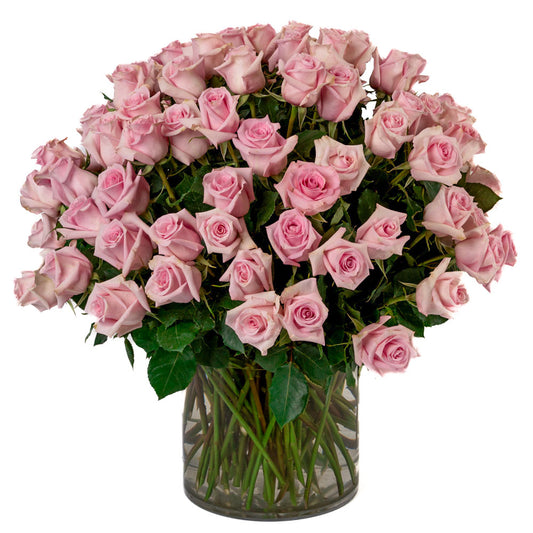 A stunning bouquet of pink roses arranged elegantly in a glass vase, perfect for any celebration.