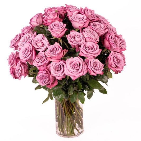 A stunning bouquet of vibrant pink roses in a clear vase, perfect for any occasion.