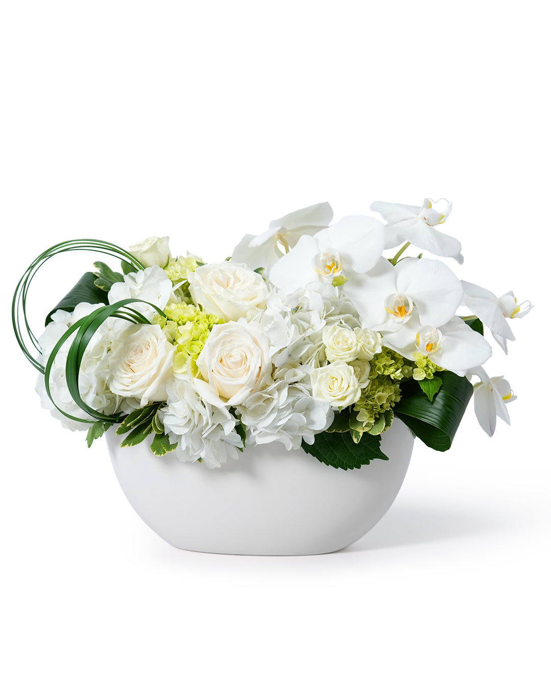Elegant white floral arrangement featuring roses, orchids, and hydrangeas in a contemporary white vase.