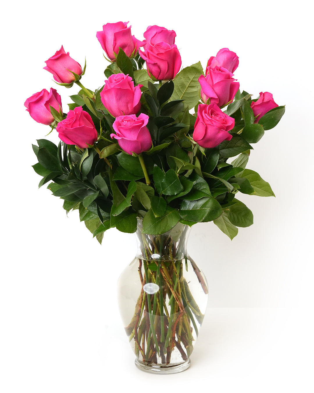 Vibrant pink roses in a clear vase, perfect for gifts or home decoration.