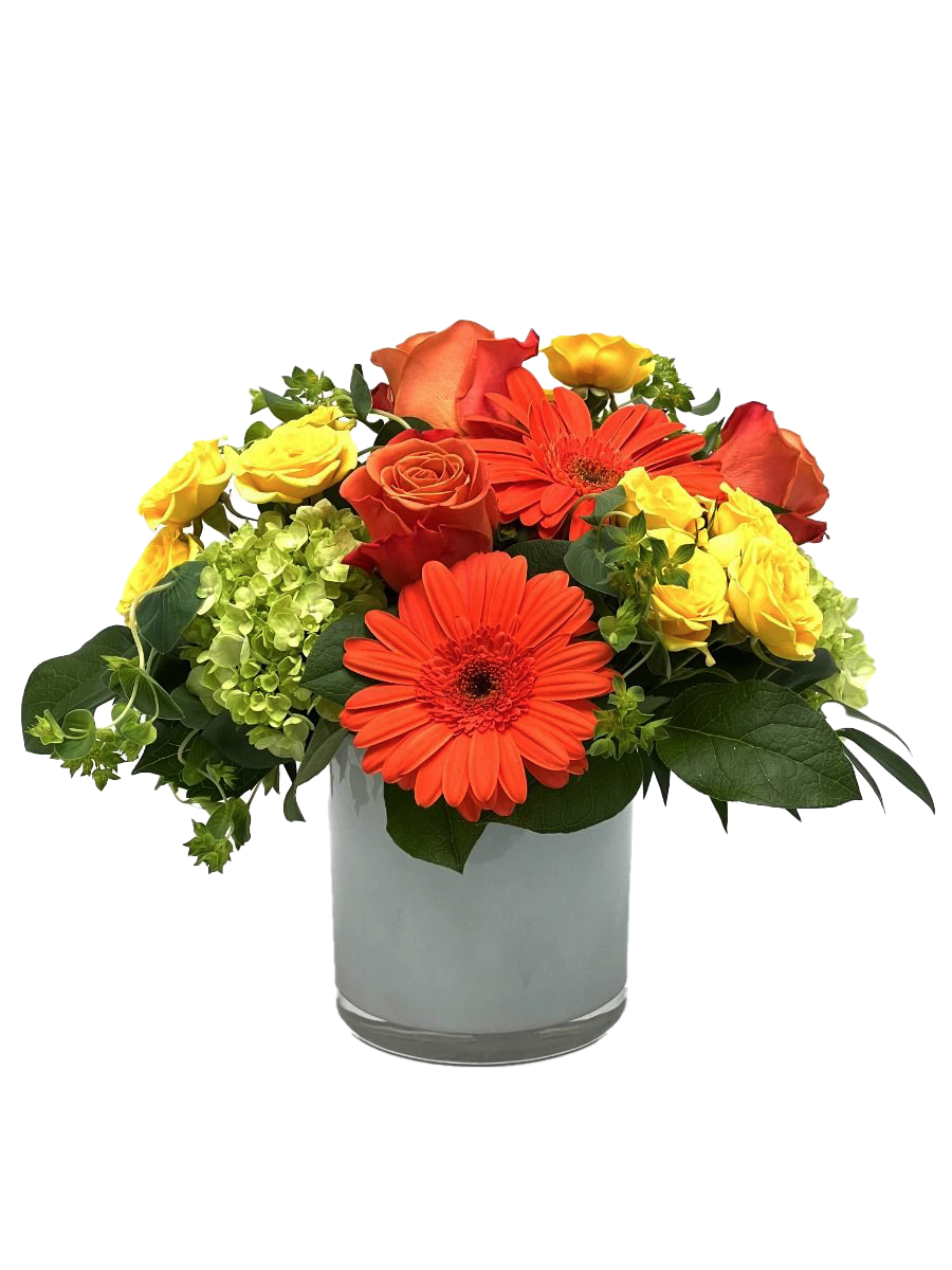 Bright and cheerful floral arrangement featuring orange gerbera daisies, yellow roses, and lush greenery.