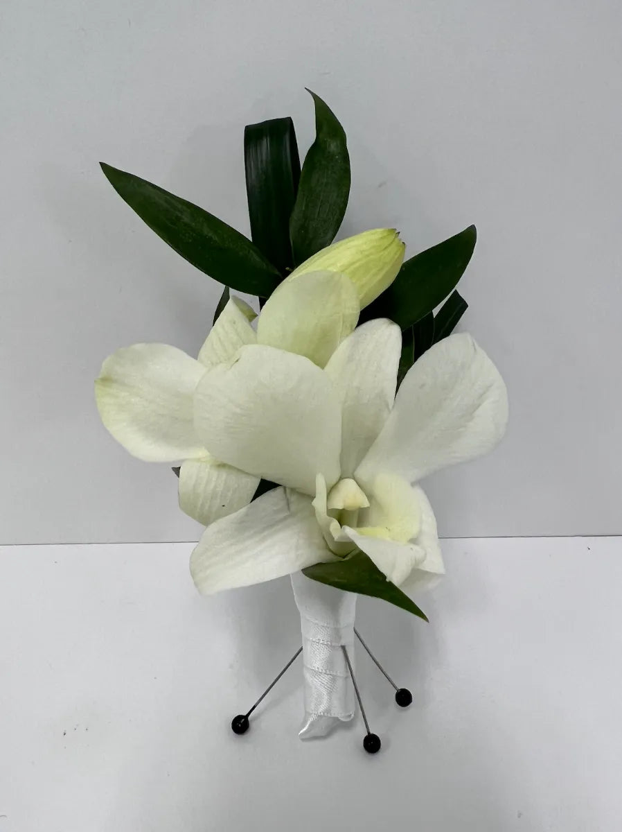 Elegant white orchid bouquet with lush green leaves, perfect for weddings or special occasions.